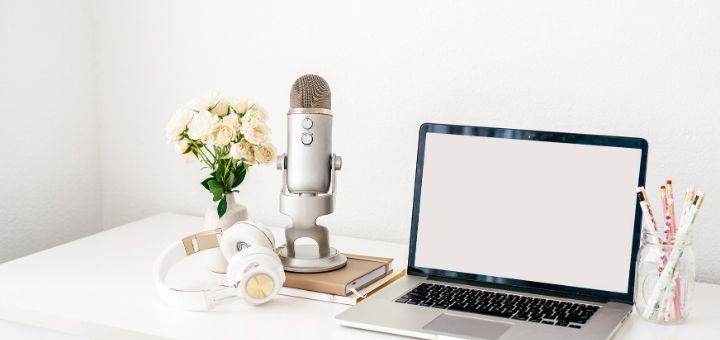 Image with laptop, headphones and microphone on the desk. - The top blogging tools and resources for bloggers in my toolkit.